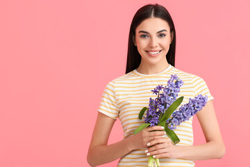 Beautiful young woman with hyacinth flowers on color background