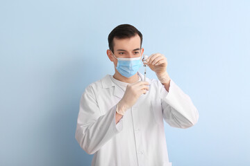 Doctor with vaccine on color background