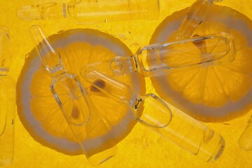 Vitamin C.ampoules with vitamin c and pieces of citrus fruit . Health and Beauty.prevention of...