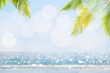 Abstract seascape with palm tree, tropical beach background. blur bokeh light of calm sea and sky....