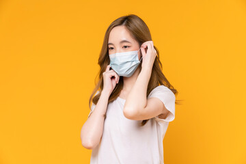 Asian woman wear masks to protect disease on yellow background.