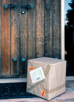 Parcel Delivered Outside Old Wooden Door Of Home