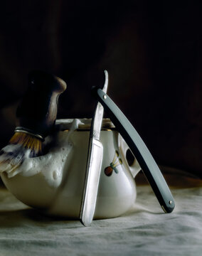 Studio shot of shaving brush, soap and cut throat razor
