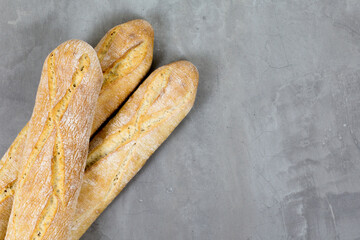 french baguette bread on grey concrete background . Diagonal. Copyspace for text