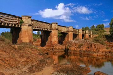 Old railway bridge over the Tinto river as it passes through Niebla
