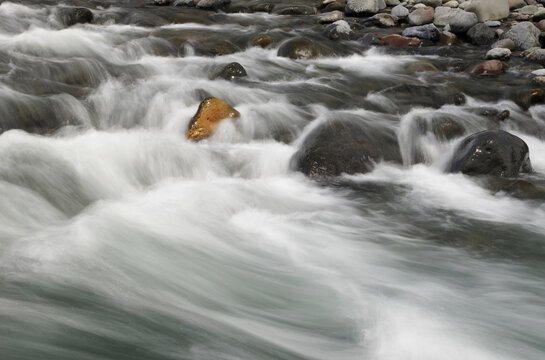 Fast flowing river over rocky river bed