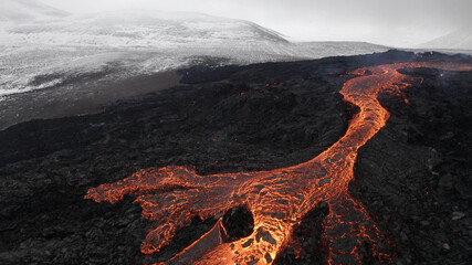 lava eruption volcano with snowy mountains, Aerial view
Hot lava and magma coming out of the...