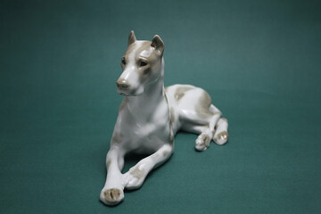 Porcelain figurine of white lying dog