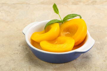 Sweet ripe canned peaches with mint