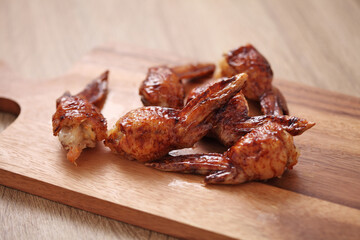 American chicken wings with barbecue sauce on cutting board