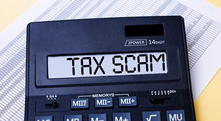 A calculator labeled TAX SCAM is on the table near the report. Financial concept