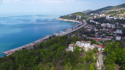 Aerial view of a beautiful mansion on the beach in a coastal town. Sochi, Russia.