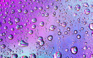 texture of drops on a rainbow background colored background