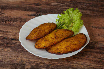 Baked potato with herbs and spices
