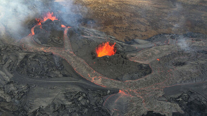 lava eruption volcano with snowy mountains, Aerial view
Hot lava and magma coming out of the crater, April 2021 
