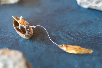 Miniature People, Miniature fishermen are fishing by boat ,The concept of a rural getaway.