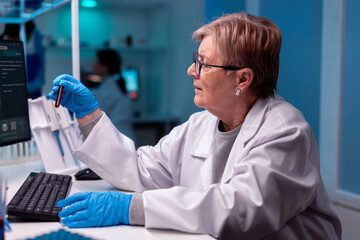 Scientist analysing blood test sample in medical facility hospital. Researcher in medicine lab working with professional technology equipment for diagnostics development and healthcare.