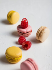 colorful macaroons with raspberries on top