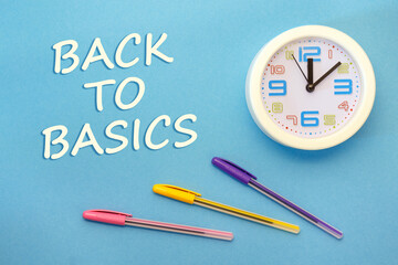 Back To Basics - lettering on a blue background and clock