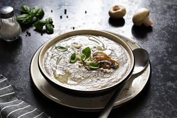 Soup puree with mushrooms and parmesan on a concrete kitchen table.Top view.