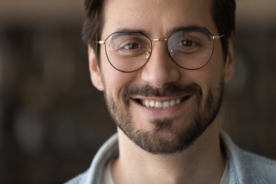 Head shot portrait close up positive bearded man with toothy healthy smile looking at camera, confident businessman in glasses posing for profile picture, happy blogger shooting vlog, recording video