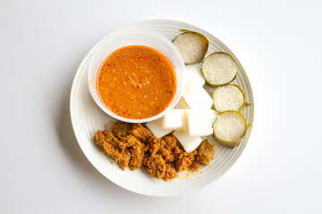 Lemang, Ketupat, rendang and curry sauce on plate.