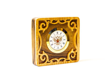 handmade wooden clock with patterns and the emblem of Russia on a white background