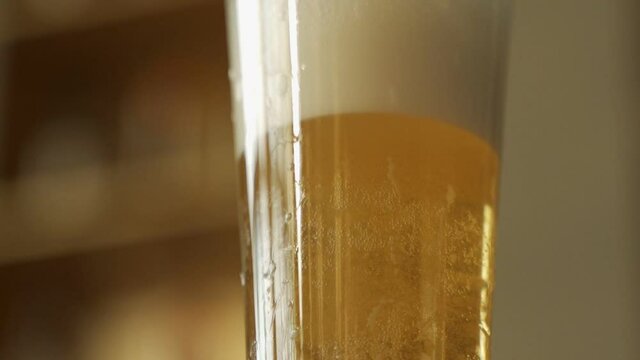 Beer is poured into glass of foam rises