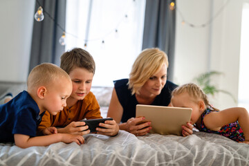 Technology addicted family parent and kids use digital devices. Internet addiction concept