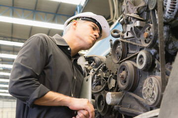 Fototapeta premium Engineer man working, Caucasian manager looking at engine used in factory-warehouse