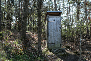 The rural wooden dry toilet standing in the wood by the cottages area. 