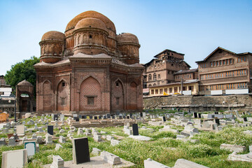 Fototapeta premium Graves surround the Tomb of Budshah, a popular tourist attraction in Srinagar, Kashmir, India.