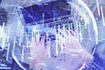 Naklejka na ściany i meble Double exposure of man's hands typing over computer keyboard and business theme hologram drawing. Top view. Financial markets concept.