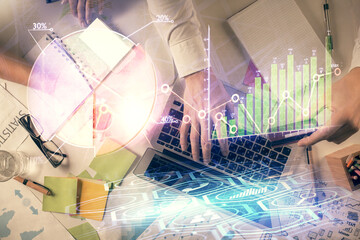 Double exposure of man and woman working together and forex graph hologram drawing. Financial...
