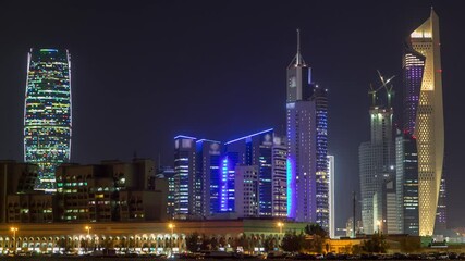 Skyline with Skyscrapers day to night timelapse in Kuwait City downtown illuminated at dusk. Kuwait City, Middle East