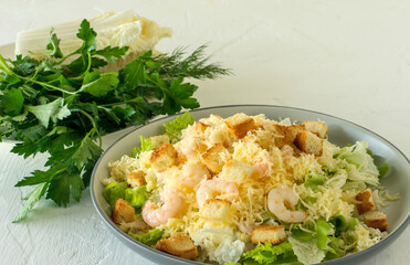 Homemade Shrimp Caesar Salad with parmesa, sauce and Croutons on a white background