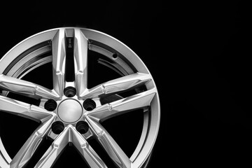Obraz premium silver alloy wheel with bifurcated beams on a black background, copy space