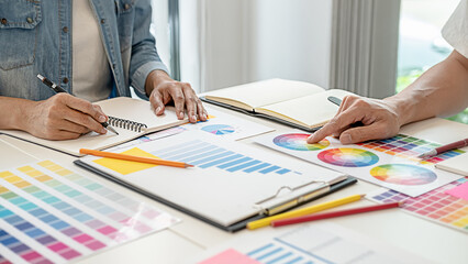 Graphic design and color swatches and pens on a desk. Architectural drawing with work tools and accessories.