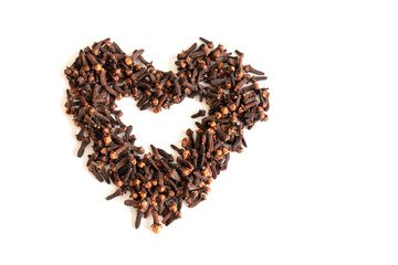 dry cloves on a white background in the shape of a heart. dry seasoning for flavor. medical application.