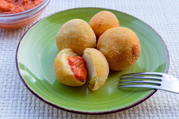 Fried potato croquettes. Tasty fried potato croquettes, with spicy sauce side dish.