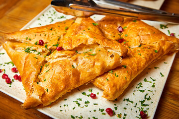 Puff pastry khachapuri with suluguni cheese. Close-up, selective focus