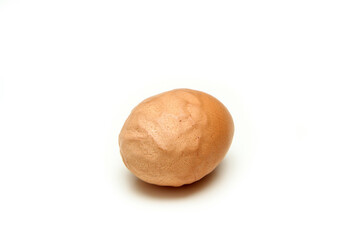 The organic egg with rough and wavy eggshell. Isolated on white background. Reason can be the old hen, insufficient nutrition or wrong process of formation of the egg. 
