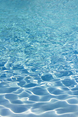 Fototapeta na wymiar Photo for background material close up on the ripples of clear blue water shining in the sunlight