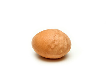 Fototapeta premium The organic egg with rough and wavy eggshell. Isolated on white background. Reason can be the old hen, insufficient nutrition or wrong process of formation of the egg. 