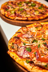 Fresh pizza with bacon, mushrooms and cheese on a light background. Close-up, selective focus