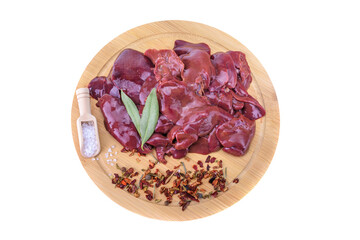 raw chicken or goose liver with spices on a round wooden cutting board close-up isolated on a white background.top view