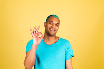 Black african man in casual on yellow background happy look to camera with smile show ok gesture