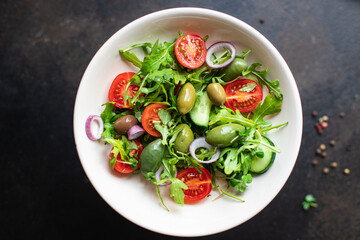 salad vegetable olives tomato cucumber, lettuce mix leaves snack meal diet vegan or vegetarian food copy space food background rustic. top view 