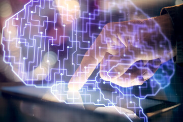 Double exposure of man's hand holding and using a digital device and brain hologram drawing. Data concept.