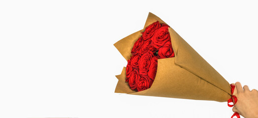 a bouquet of scarlet roses in craft paper on a white background with a copy of the space
